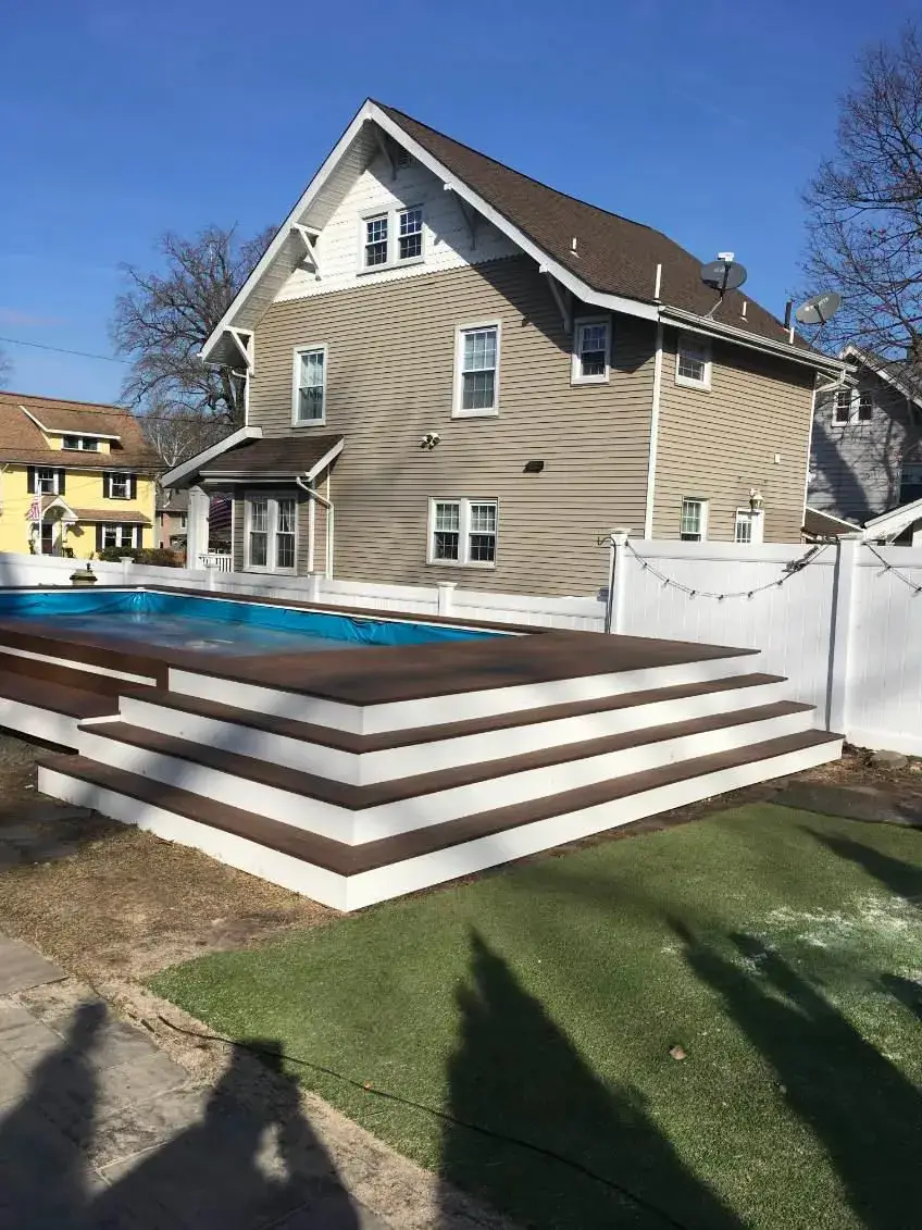 Finished Pool Deck — Completed composite pool deck with wide cascading steps and turf, Bergen County NJ