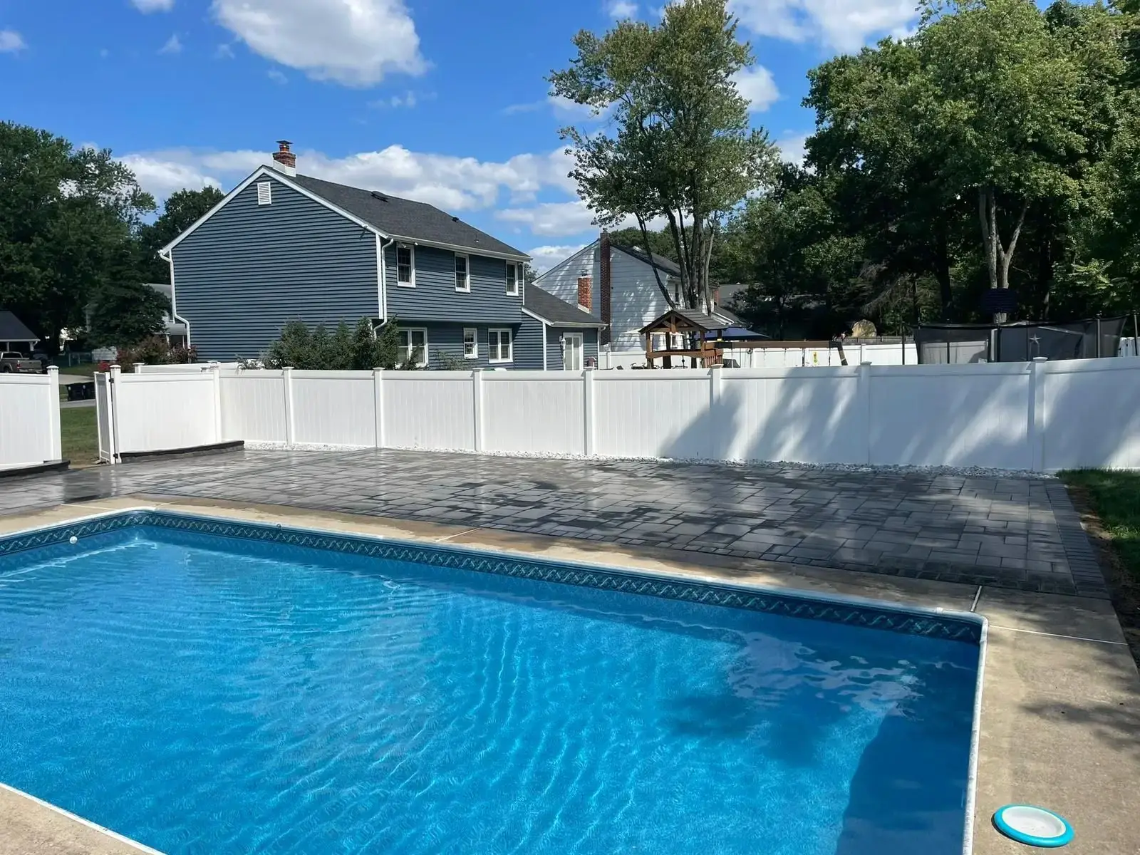 Paver Pool Deck — Paver pool deck with white privacy fence in Bergen County, Bergen County NJ