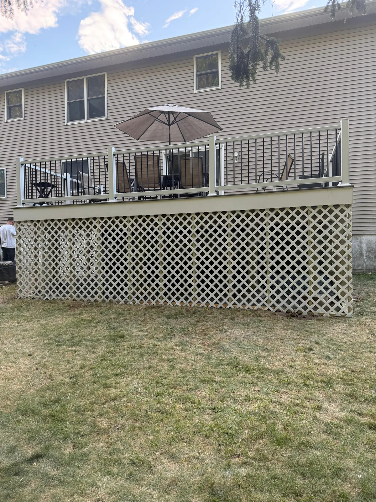 Composite Deck & Aluminum Railing — Back elevation of a composite deck with black aluminum balusters and white lattice skirting, Bergen County NJ
