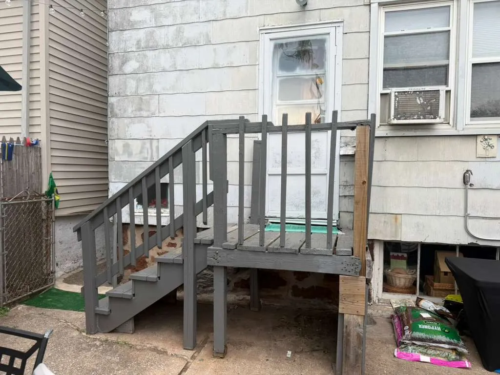 Before: Old Wood Porch — The original weathered painted-wood back porch and stairs before replacement, Bergen County NJ